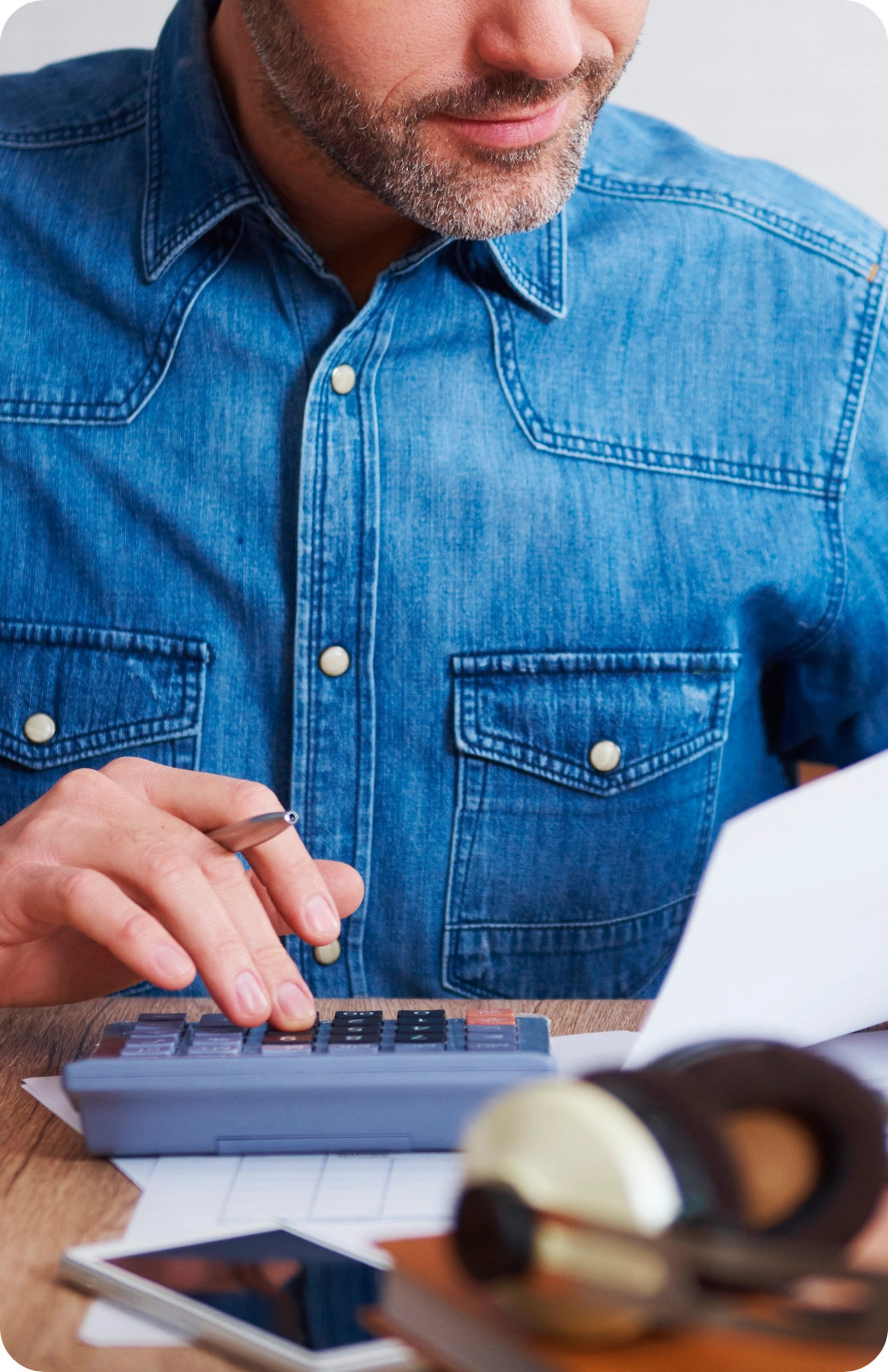 Businessman_Calculating_His_Monthly_Expenses_Horizontal Businessman Calculating His Monthly Expenses